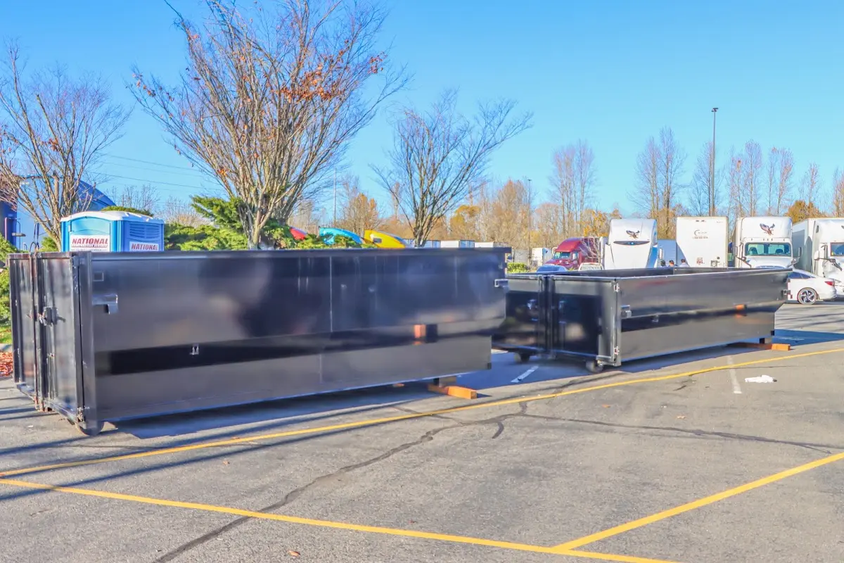 Professional dumpster rental service with roll-off container on residential driveway in Ocean City